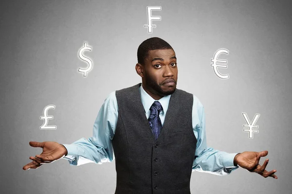 Confused, business man standing, juggling with currency icons — Stock Photo, Image