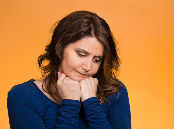 Hnhappy middle age woman, ooking down, bothered by something