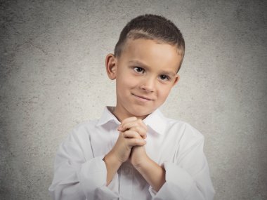 Boy gesturing with clasped hands, pretty please with sugar on top clipart