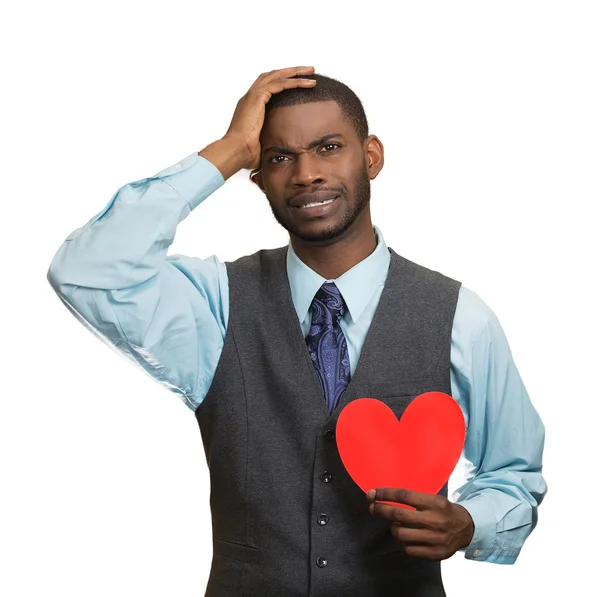 Heartbroken man, holding red heart in hand — Stock Photo, Image