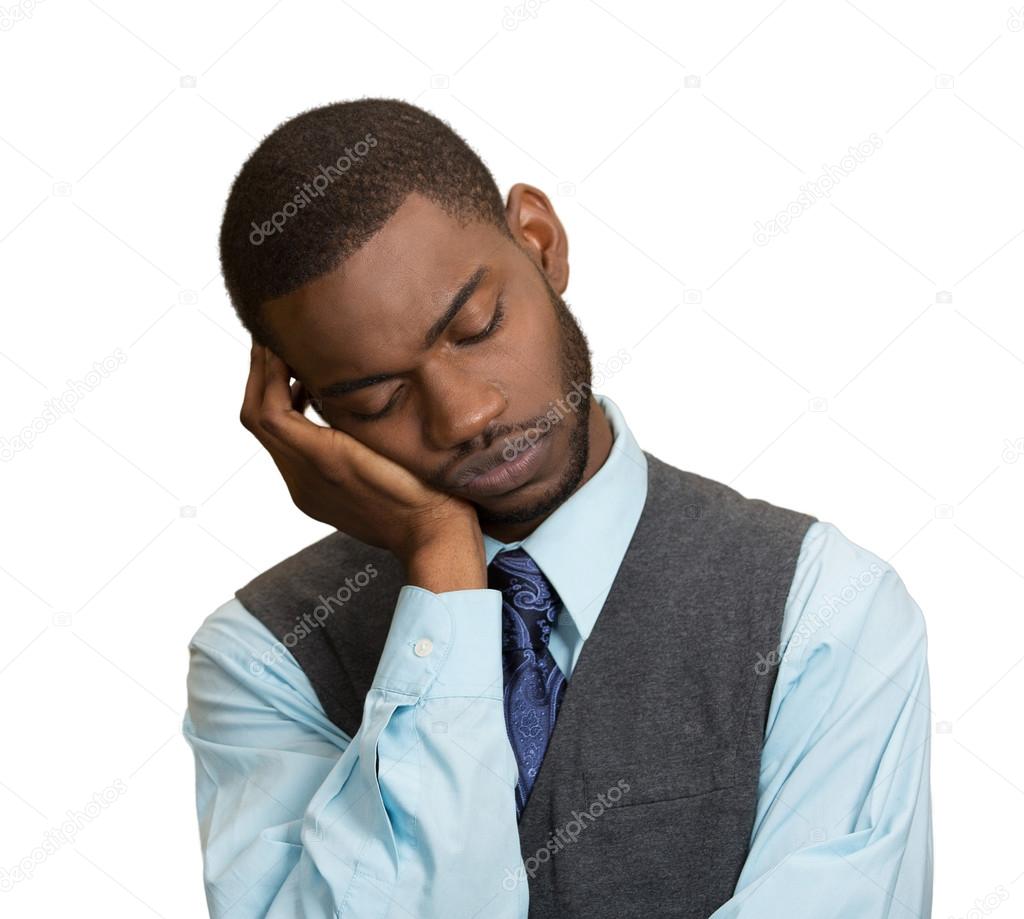 Sleepy young Business Man, placing head on hand, tired