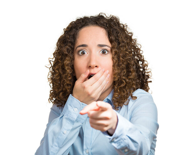 Surprised, shocked young woman pointing with finger at something