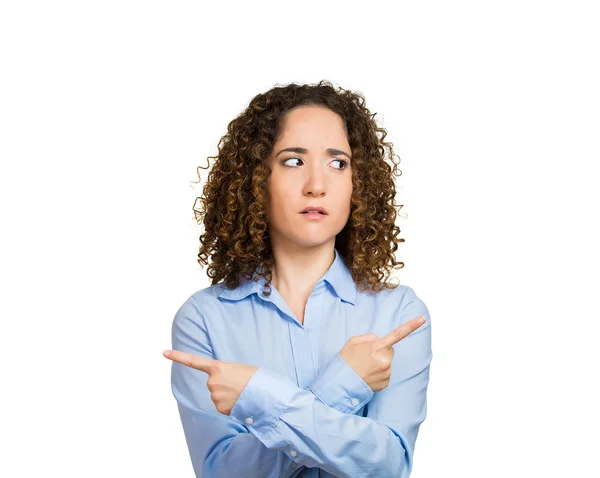 Confused woman pointing in two different directions — Stock Photo, Image