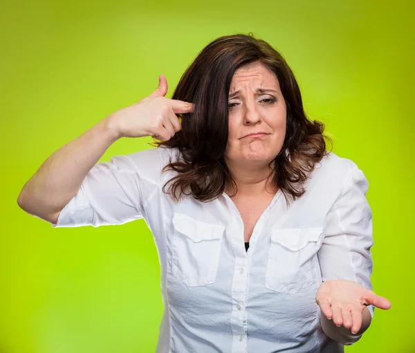 Angry woman gesturing with finger against temple asking are you crazy? — Stock Photo, Image