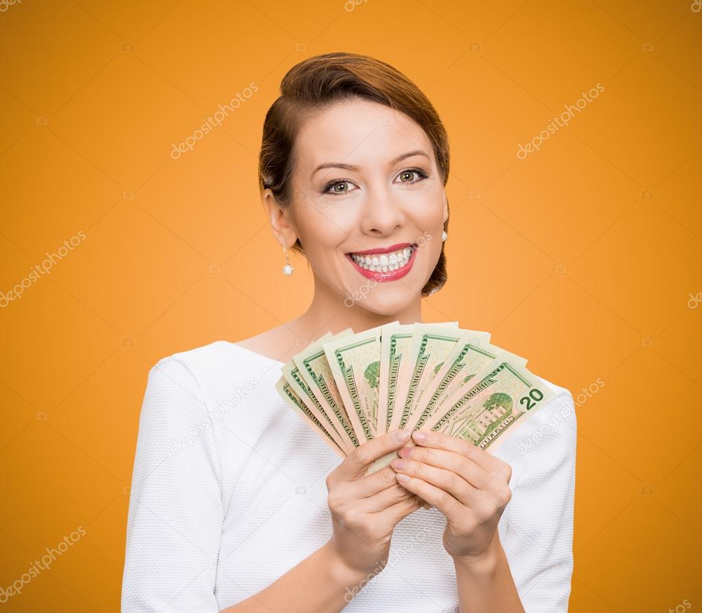 Successful young business woman holding money