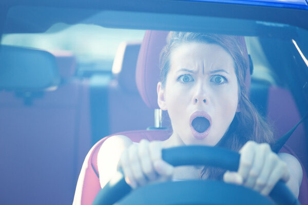 Fright face of woman driving car