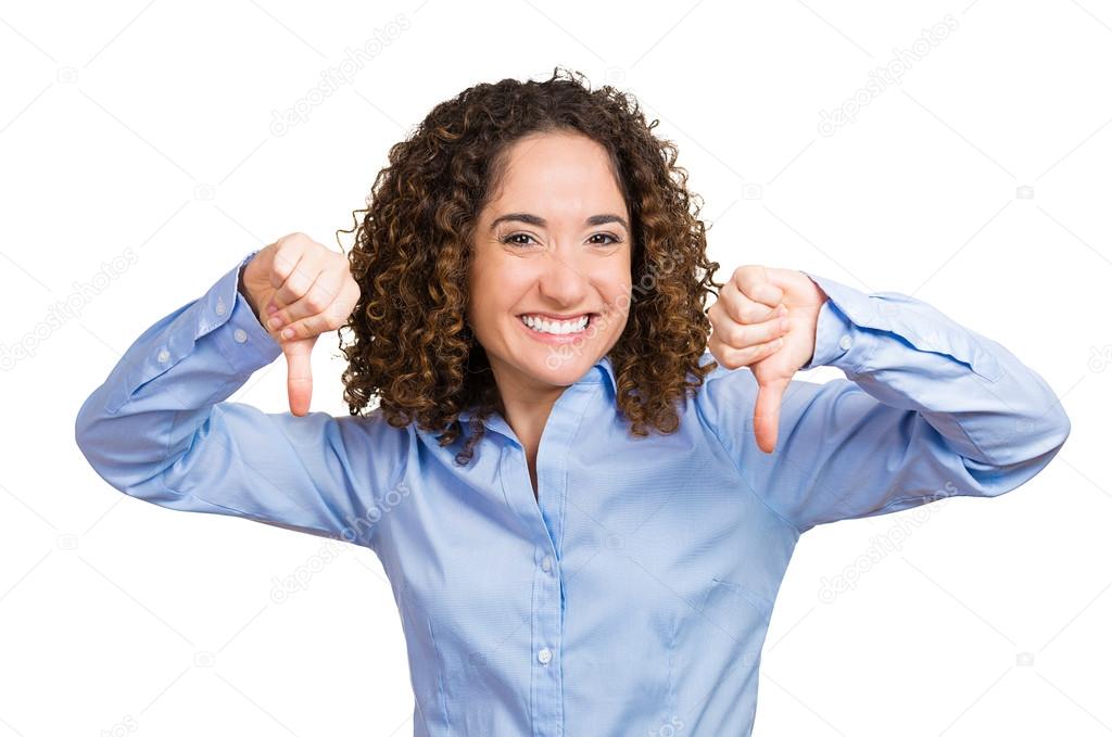 Young woman showing thumbs down, happy someone failed
