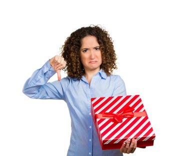 Displeased woman holding opening christmas red gift box clipart