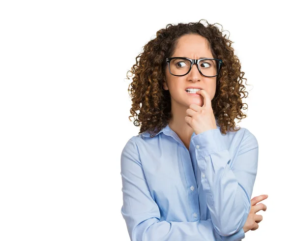 Nervous woman with glasses biting her fingernails — Stock Photo, Image