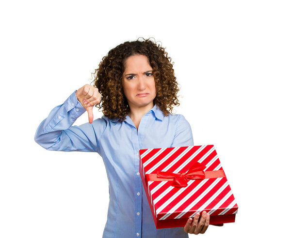 Displeased woman holding opening christmas red gift box