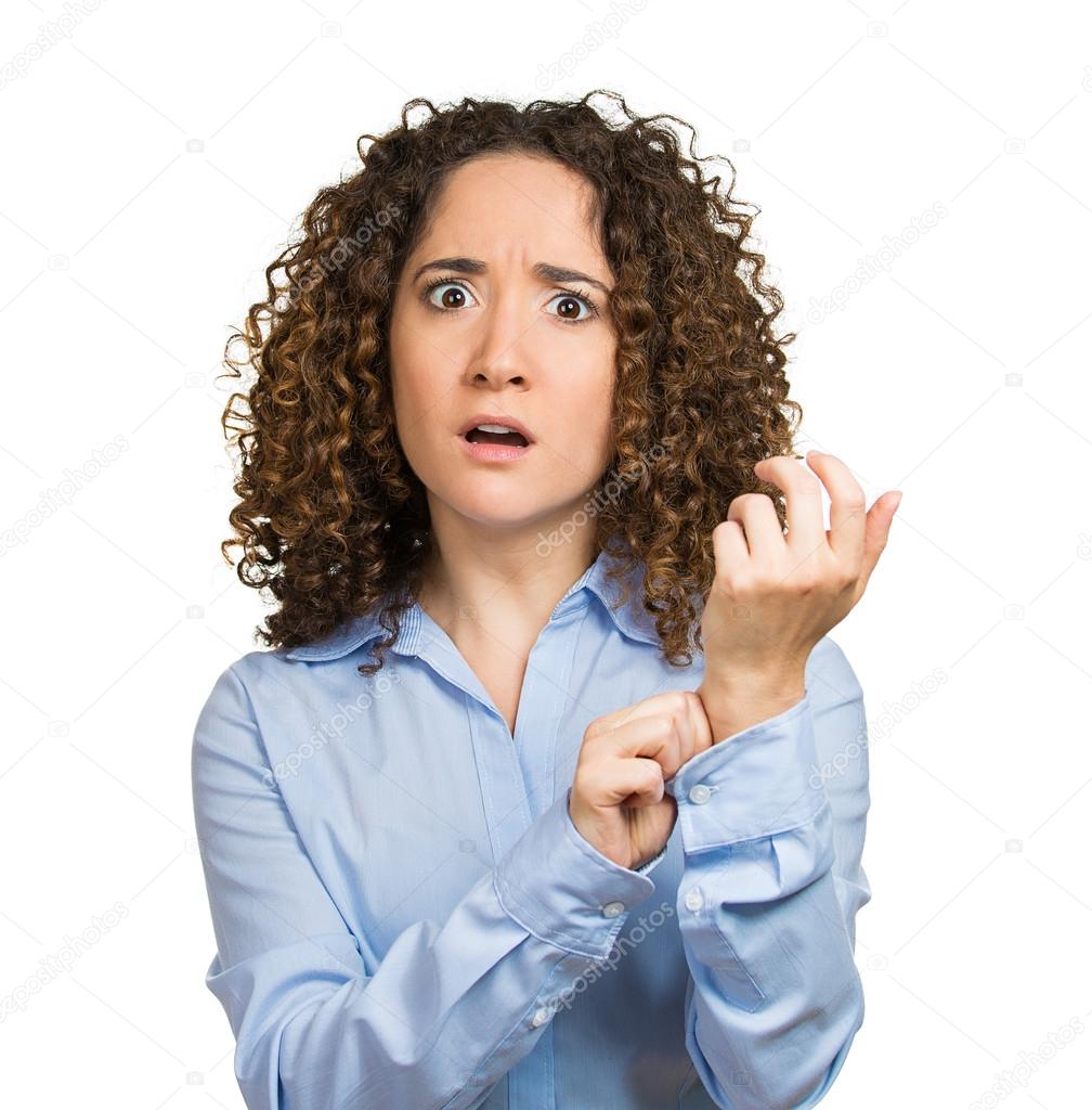 Surprised woman pinching her arm skin, giving reality check gesture
