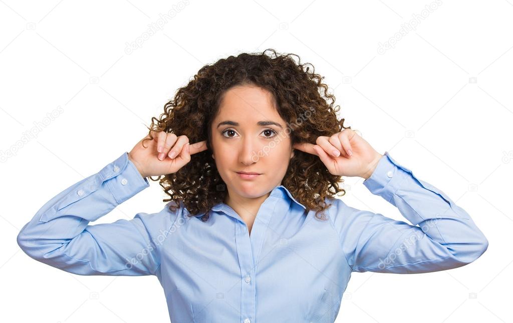 Woman covering closed ears annoyed by loud noise or ignoring someone