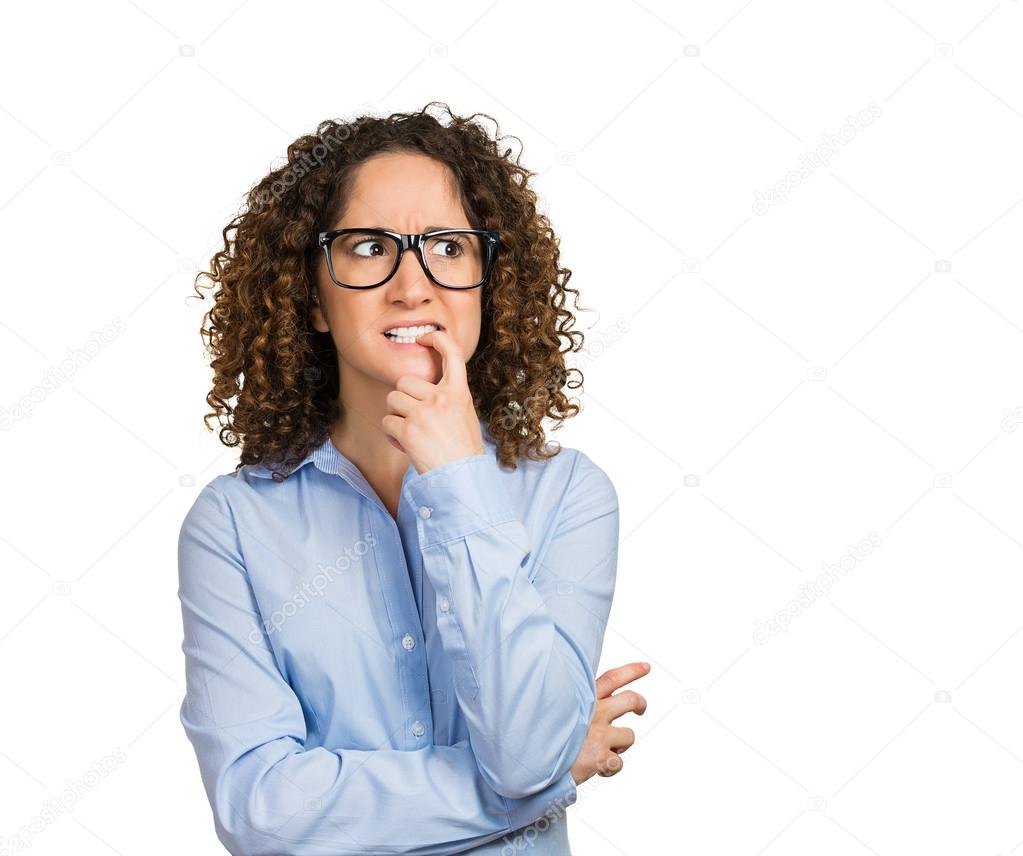 Nervous woman with glasses biting her fingernails