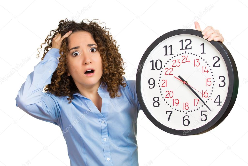 Woman, worker, holding clock looking anxiously, pressured by lack of time