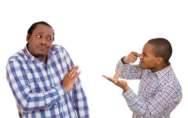 Man looking at guy, accusing, pointing at him covering nose