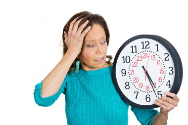 Senior woman holding clock looking anxiously pressured by lack of time clipart