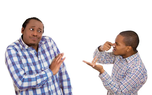 Man looking at guy, accusing, pointing at him covering nose — Stock Photo, Image