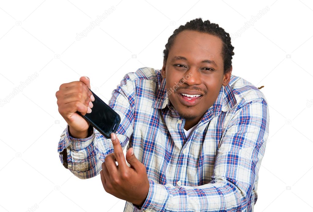 Angry, young man showing broken smartphone with crashed screen