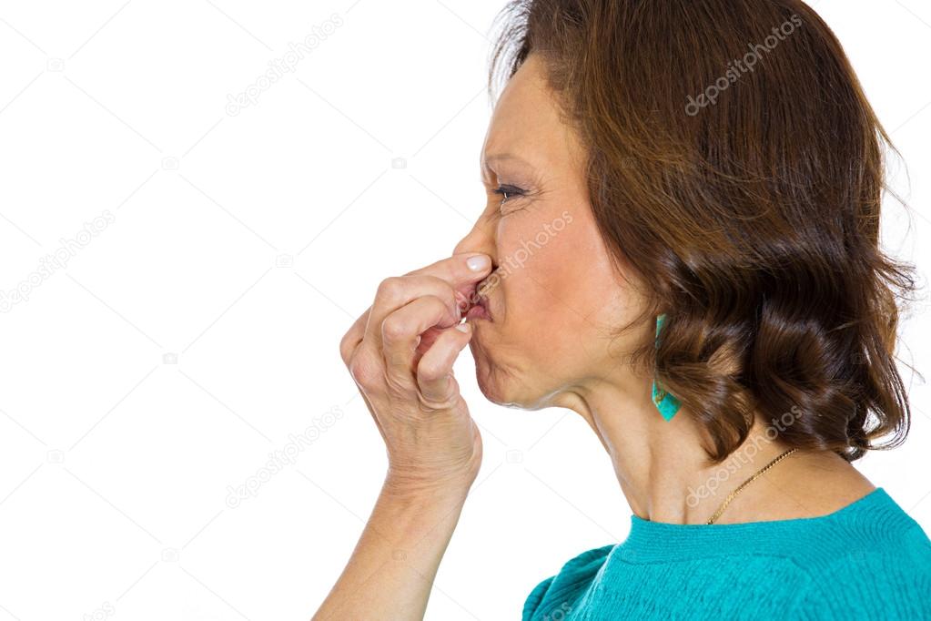 Woman pinches nose bad smell