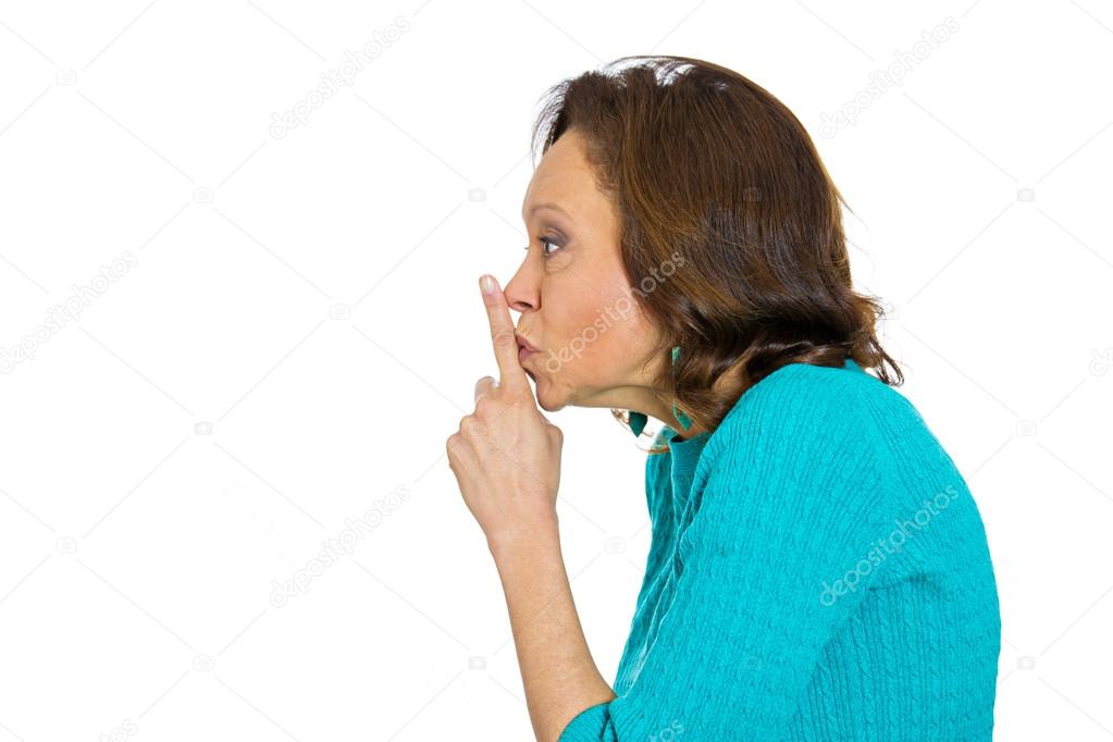 Senior woman placing finger hand on lips, shh gesture, quiet silence