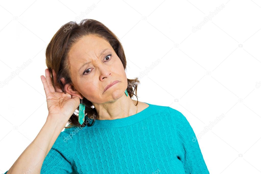 Nosy worried funny senior mature woman, hand to ear, trying to listen eavesdropping