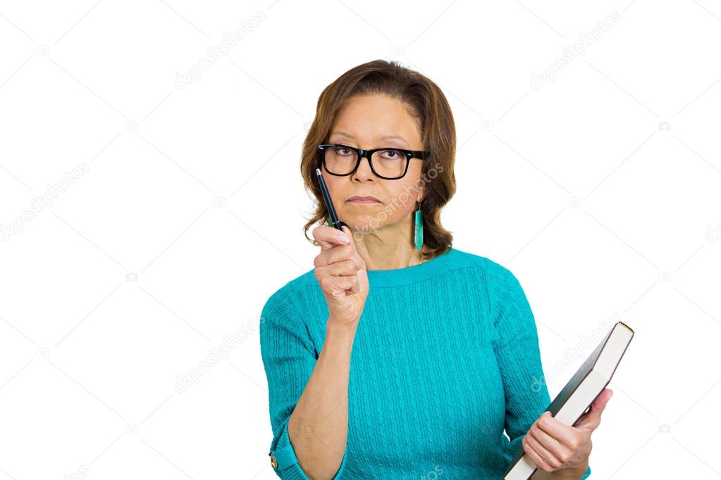 Elderly female teacher holding book, pen, looking very serious