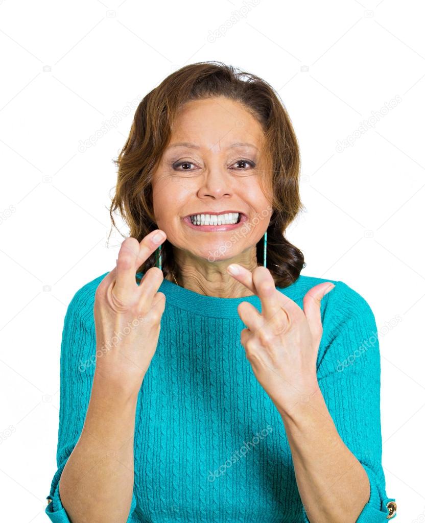 Mature, funny looking woman crossing fingers