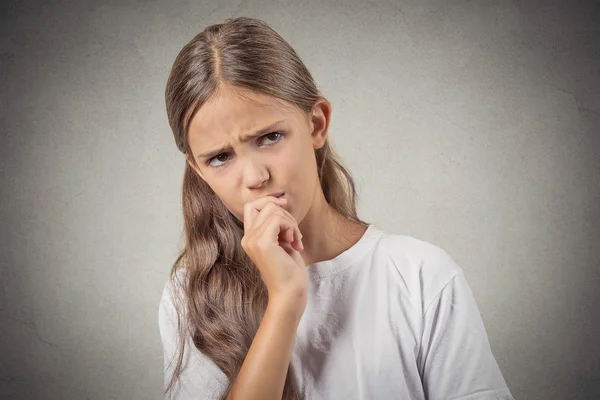 Skeptical young girl looking suspicious — Stock Photo, Image