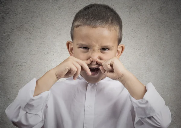 Boy disgust on face pinches nose something stinks — Stock Photo, Image
