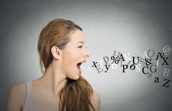 Woman talking with alphabet letters coming out of mouth — Stock Photo, Image