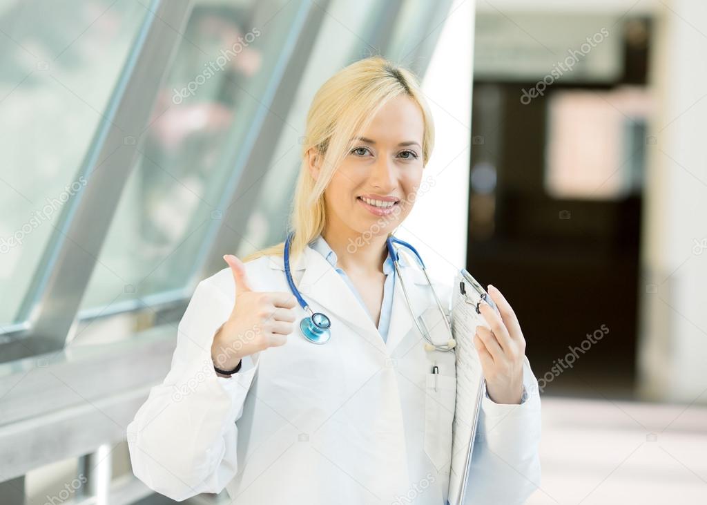 female health care professional giving thumbs up
