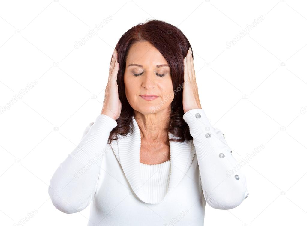 woman covering ears, closing her eyes