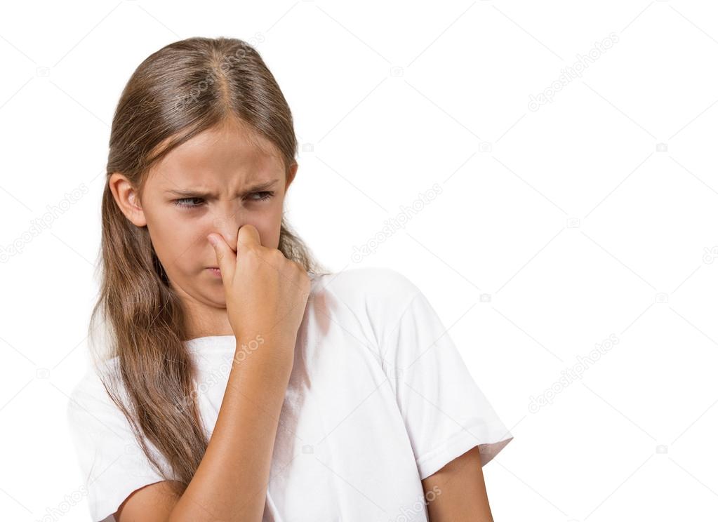 girl with disgust on face pinches nose