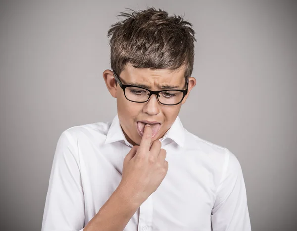 Annoyed boy with finger in mouth, disgusted — Stock Photo, Image