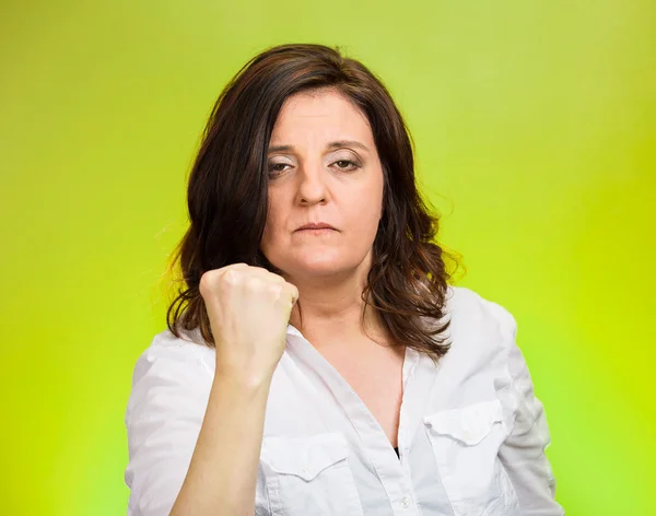 Angry woman putting up fist warning Stock Image