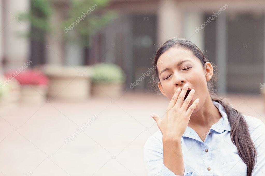 sleepy young business woman yawning