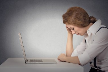 Depressed woman in front of laptop clipart