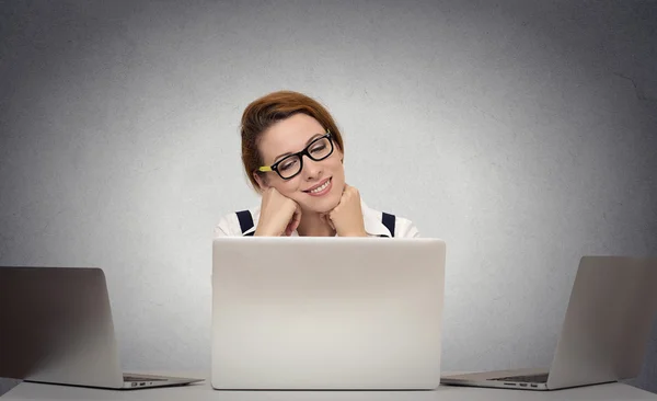 Woman dreaming while working on multiple computers — Stock Photo, Image