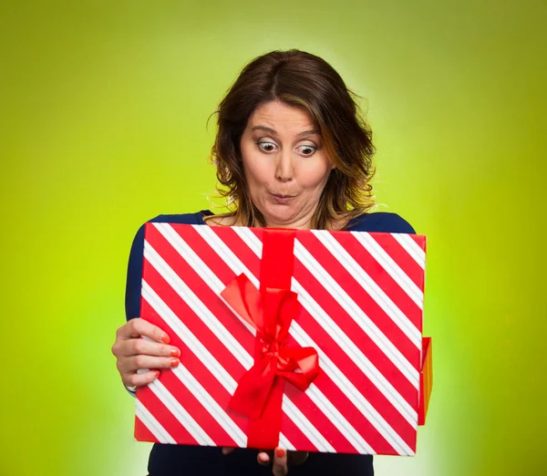 Woman opening red gift box, surprised — Stock Photo, Image