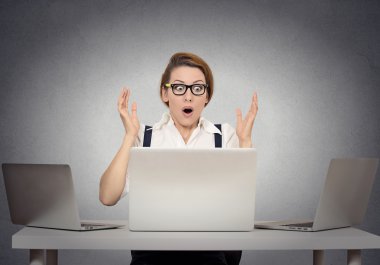 Stressed shocked woman sitting at table in front of computer clipart