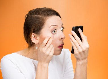 woman pulling down eyelid checking her eye  clipart