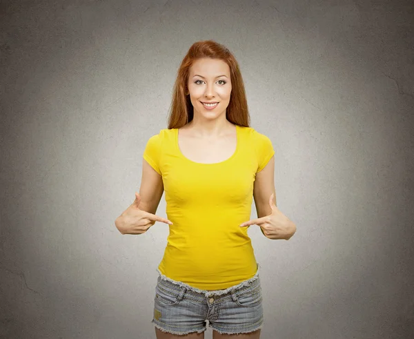 Woman pointing at blank yellow t-shirt — Stock Photo, Image