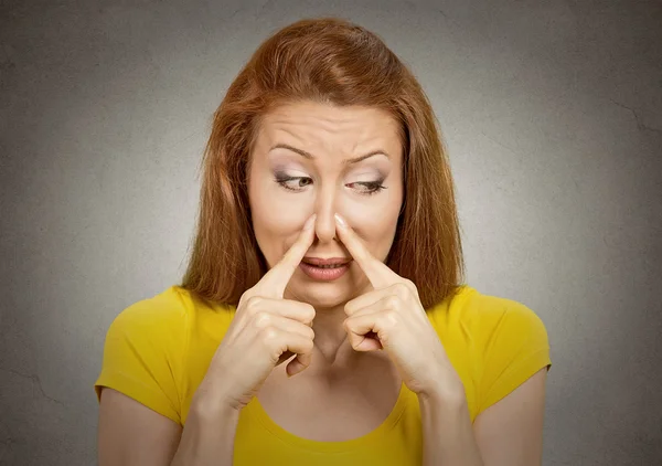 Woman pinches nose with fingers something stinks — Stock Photo, Image