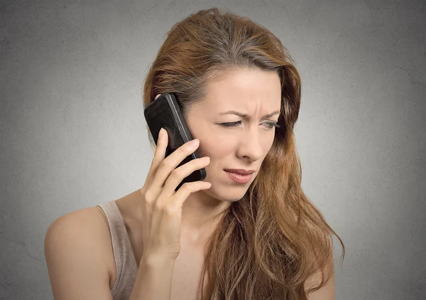 Unhappy serious woman talking on phone — Stock Photo, Image