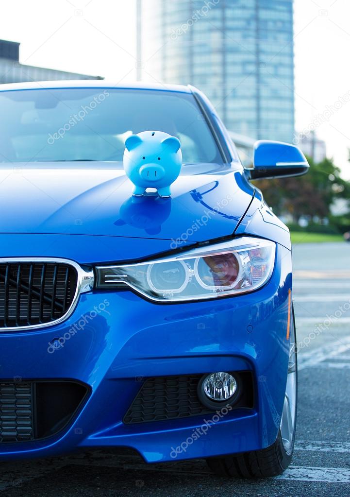 car with piggy bank on hood