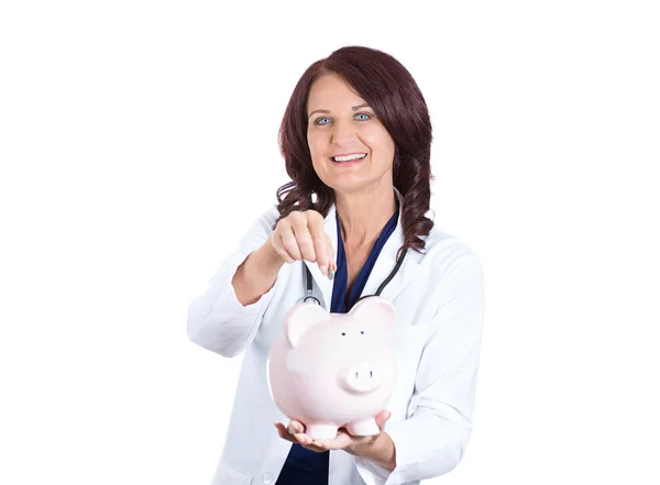 Doctor holding piggy bank — Stock Photo, Image