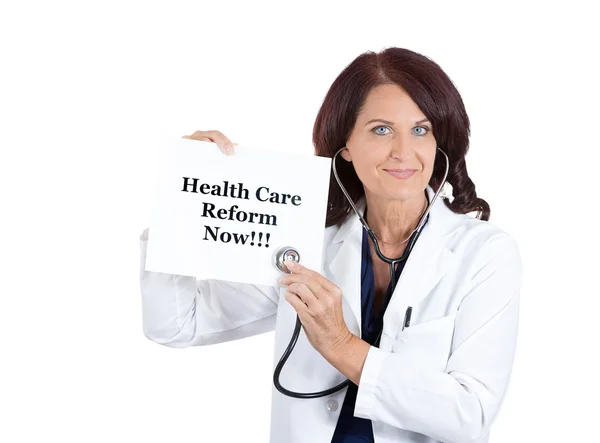 Doctor with stethoscope holding health care reform now sign — Stock Photo, Image