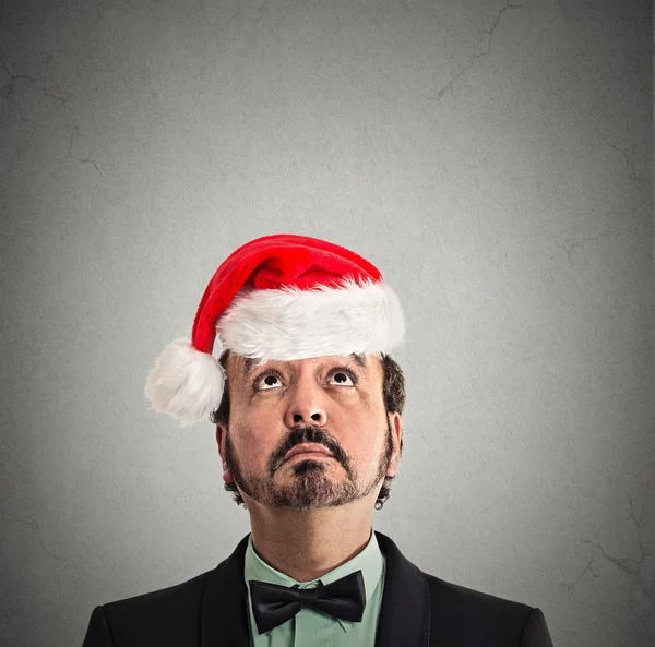 Xmas man with red santa claus hat looking up — Stock Photo, Image