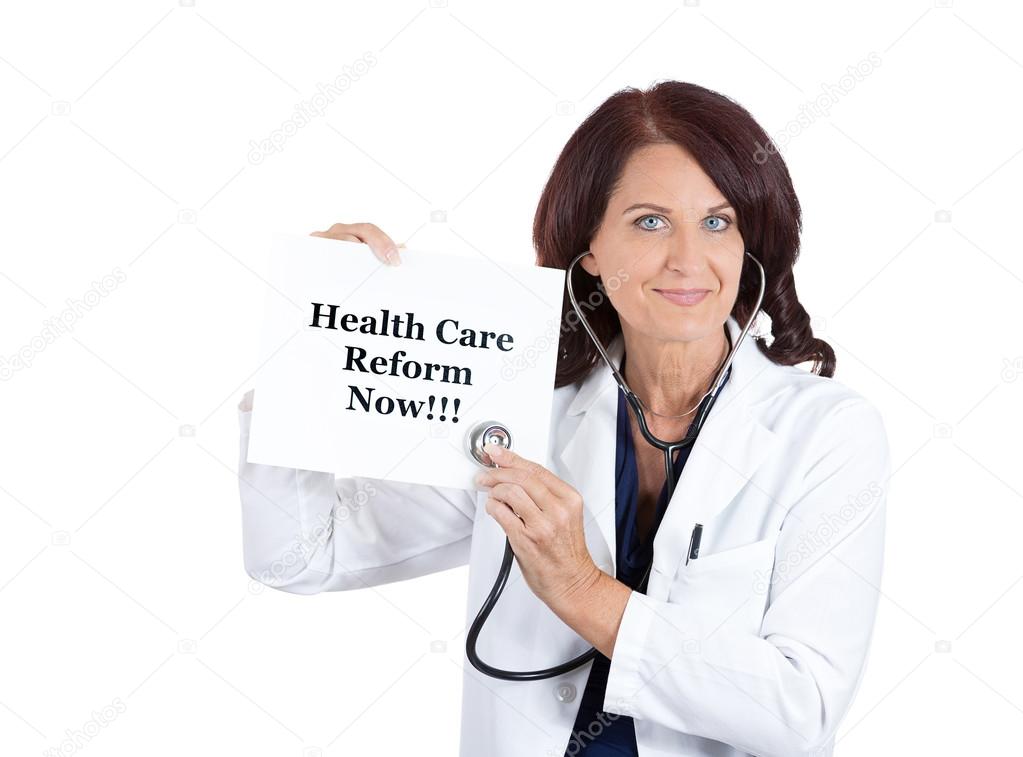 doctor with stethoscope holding health care reform now sign
