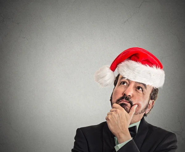 Xmas man with red santa claus hat looking up — Stock Photo, Image